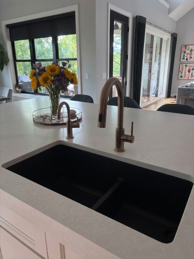 Bronze reverse osmosis drinking water faucet on a white quartz counter in a Des Moines area kitchen