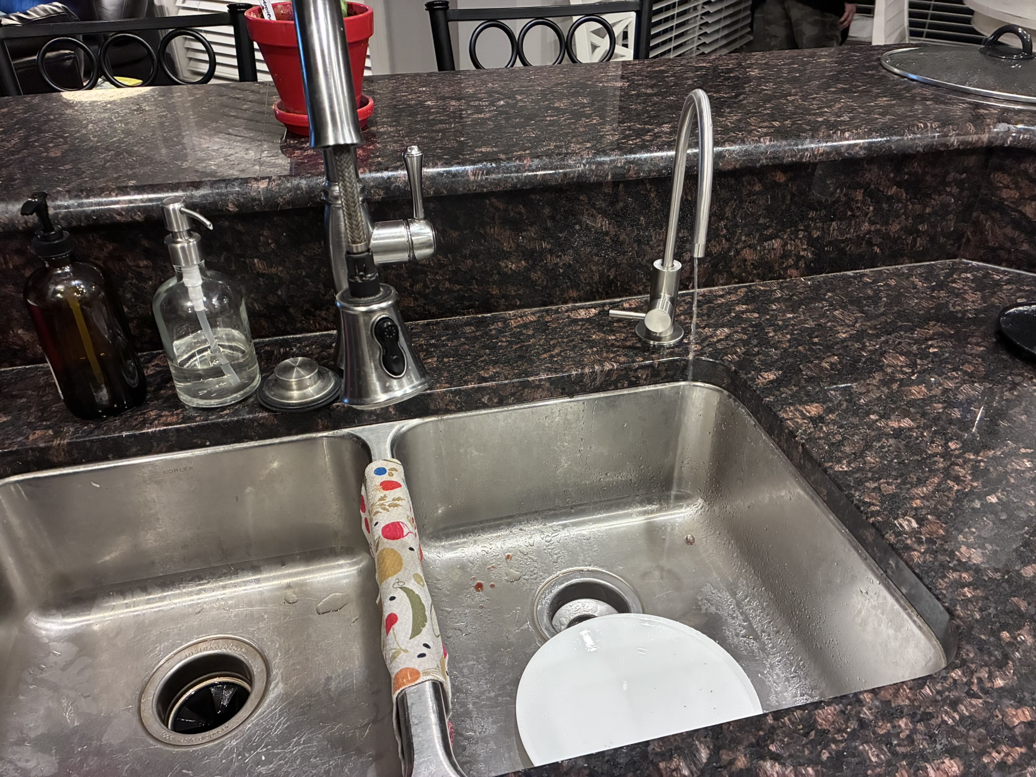 RO faucet installed on dark granite kitchen sink after installation
